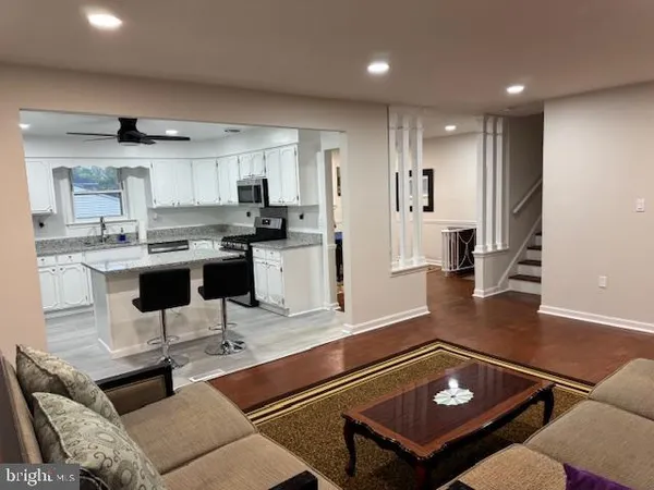 a kitchen with stainless steel appliances granite countertop a stove and a refrigerator