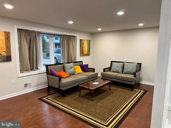 a view of a dining room with furniture and a rug