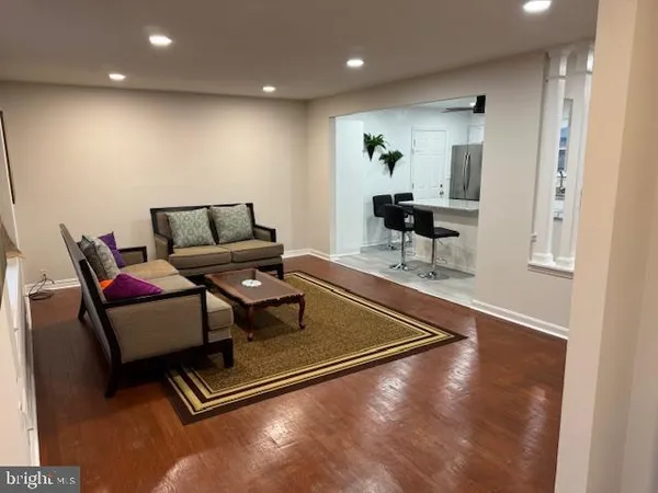 a kitchen with stainless steel appliances granite countertop a refrigerator a stove a sink a stove a dining table and chairs
