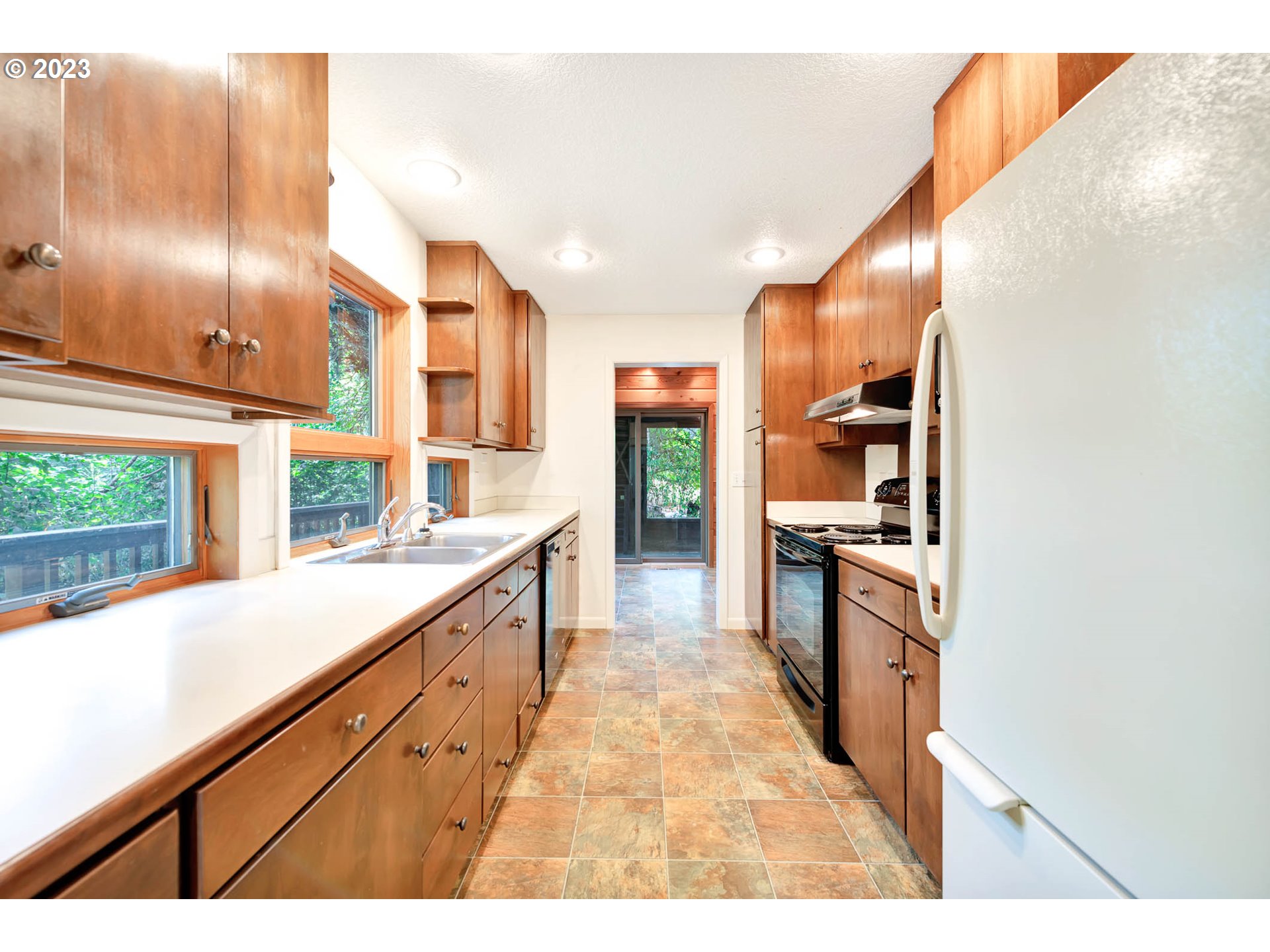 77383 Mosby Creek Road Cottage Grove, OR 97424 - Photo 11 of 48 a large kitchen with cabinets and wooden floor