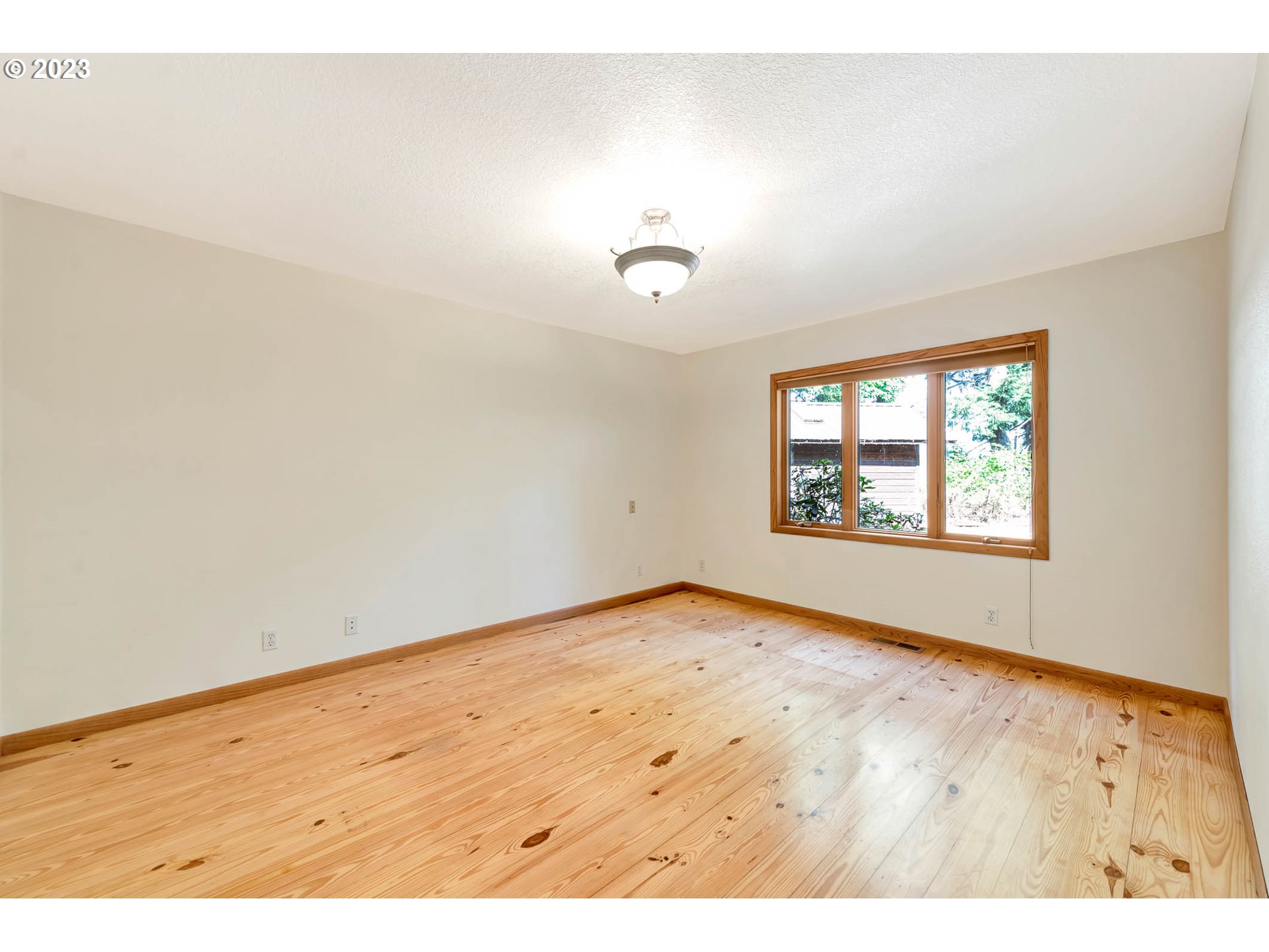77383 Mosby Creek Road Cottage Grove, OR 97424 - Photo 20 of 48 an empty room with wooden floor and windows