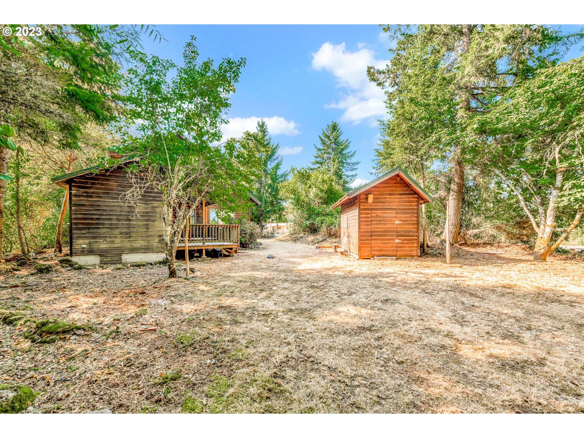 77383 Mosby Creek Road Cottage Grove, OR 97424 - Photo 37 of 48 a backyard of a house with table and chairs