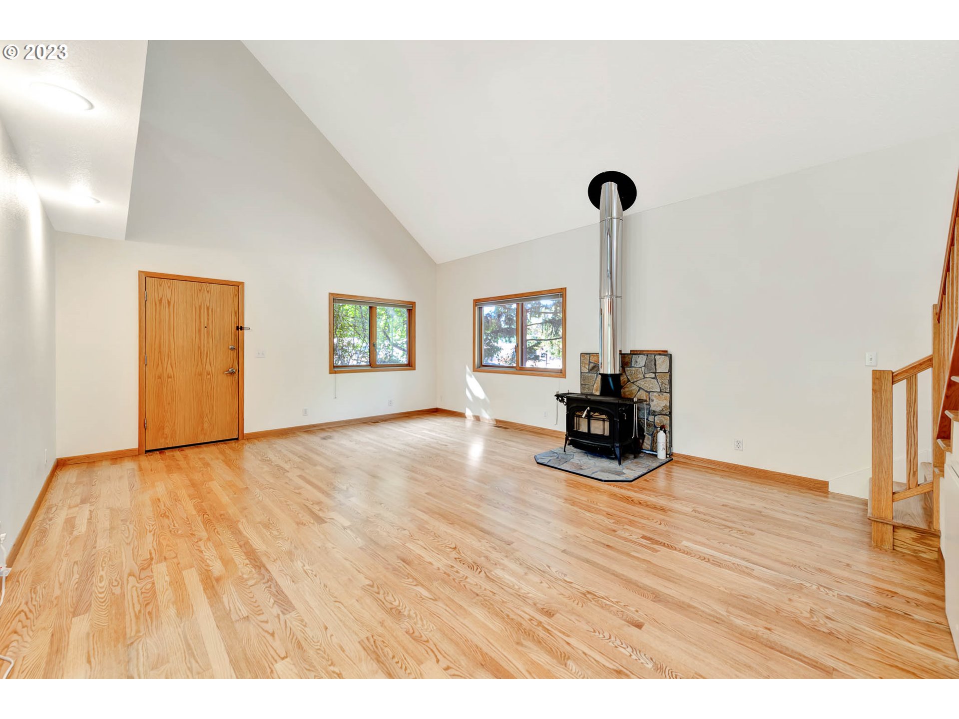 77383 Mosby Creek Road Cottage Grove, OR 97424 - Photo 6 of 48 a view of empty room with wooden floor and ceiling fan
