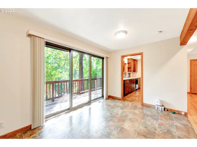 a large kitchen with cabinets and wooden floor