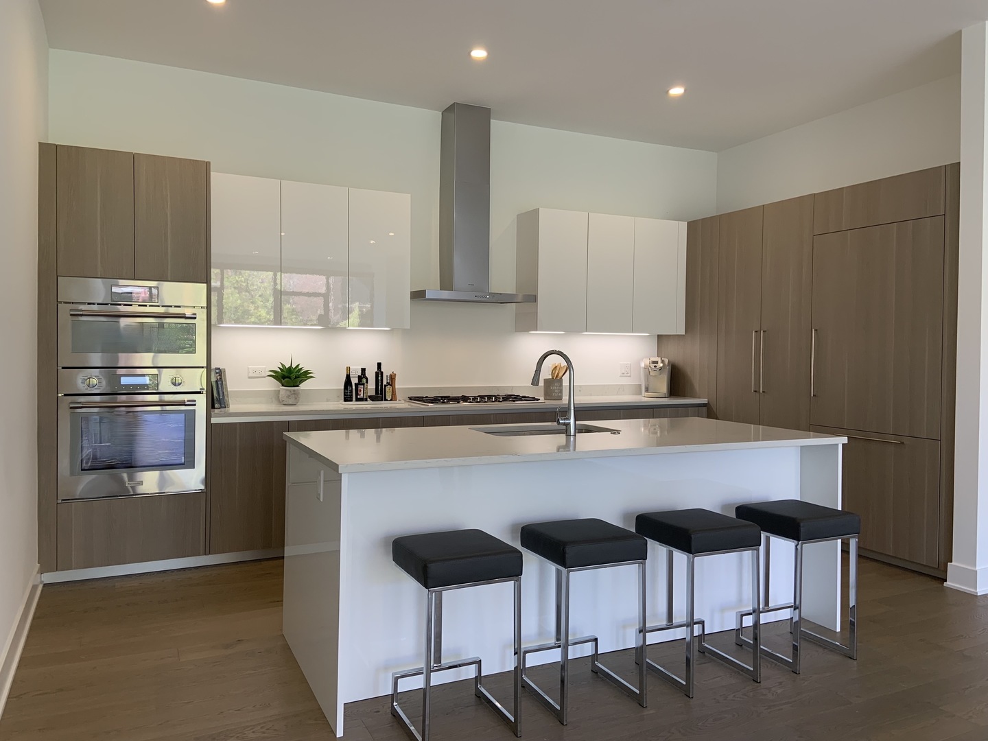 6 North Bishop Street, Unit 203 Chicago, IL 60607 - Photo 3 of 17 a kitchen with stainless steel appliances a dining table chairs refrigerator and sink