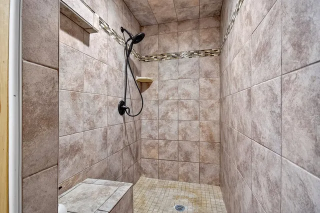a view of a house with a yard potted plants and a large tree