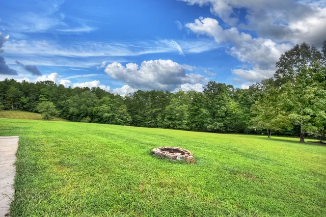 a view of a patio with a table chairs and backyard