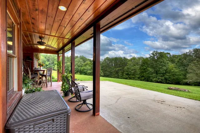 a view of a porch with furniture and garden