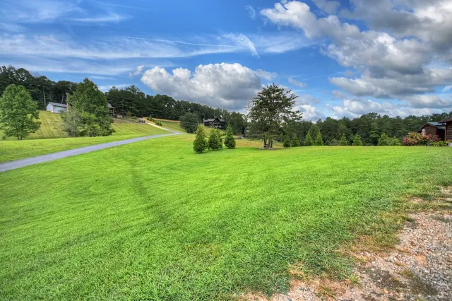 a living room with furniture a clock on wall and a window