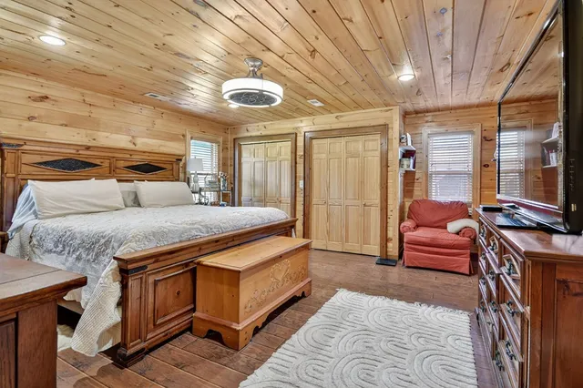 a spacious bedroom with a bed and a chandelier