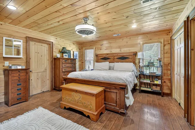 a bedroom with a bed and a large window