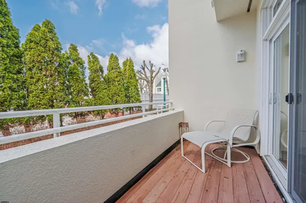 a view of a balcony with chairs