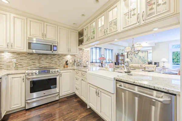 a kitchen with stainless steel appliances granite countertop a stove and a sink