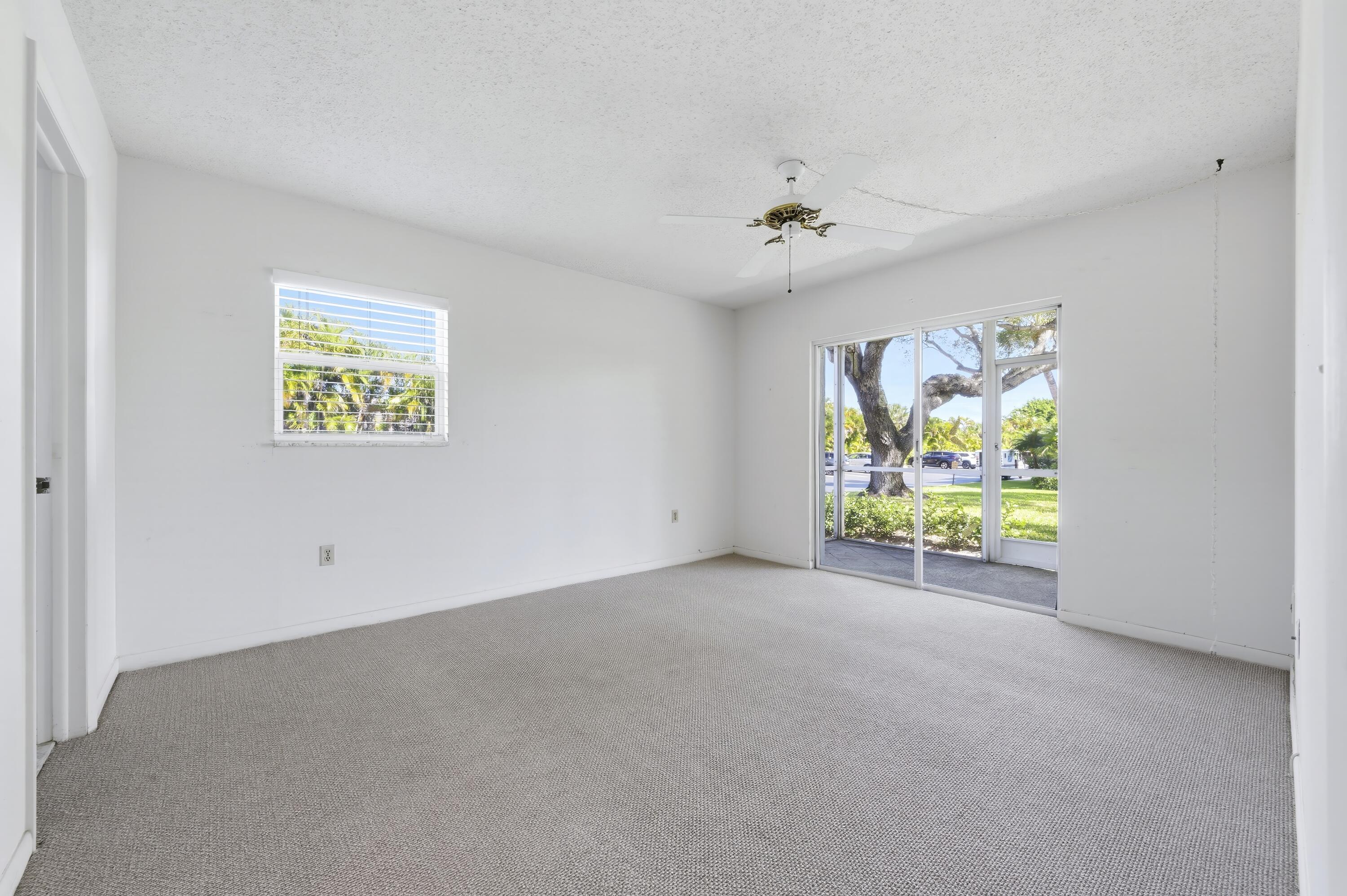 717 Highway 1, Unit 201 Jupiter, FL 33477 - Photo 12 of 31 an empty room with windows and painted walls