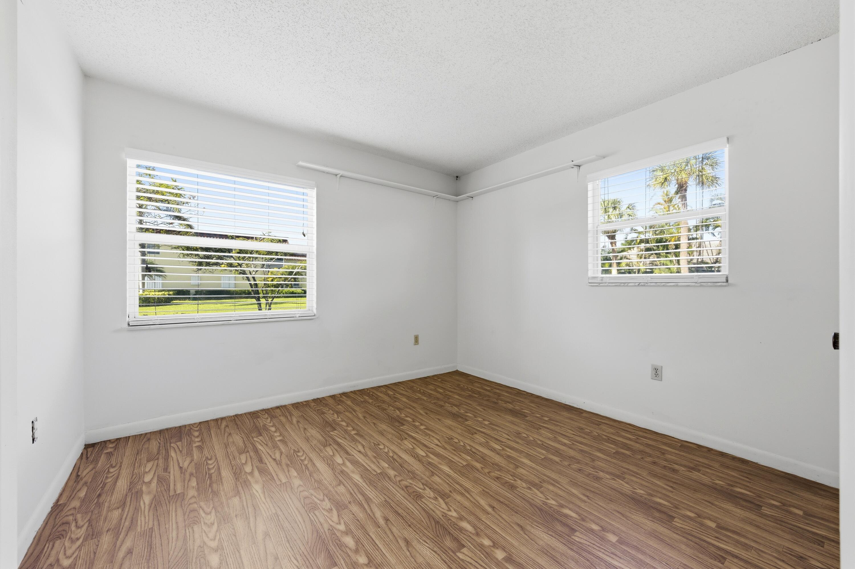717 Highway 1, Unit 201 Jupiter, FL 33477 - Photo 15 of 31 a view of an empty room with wooden floor and a window