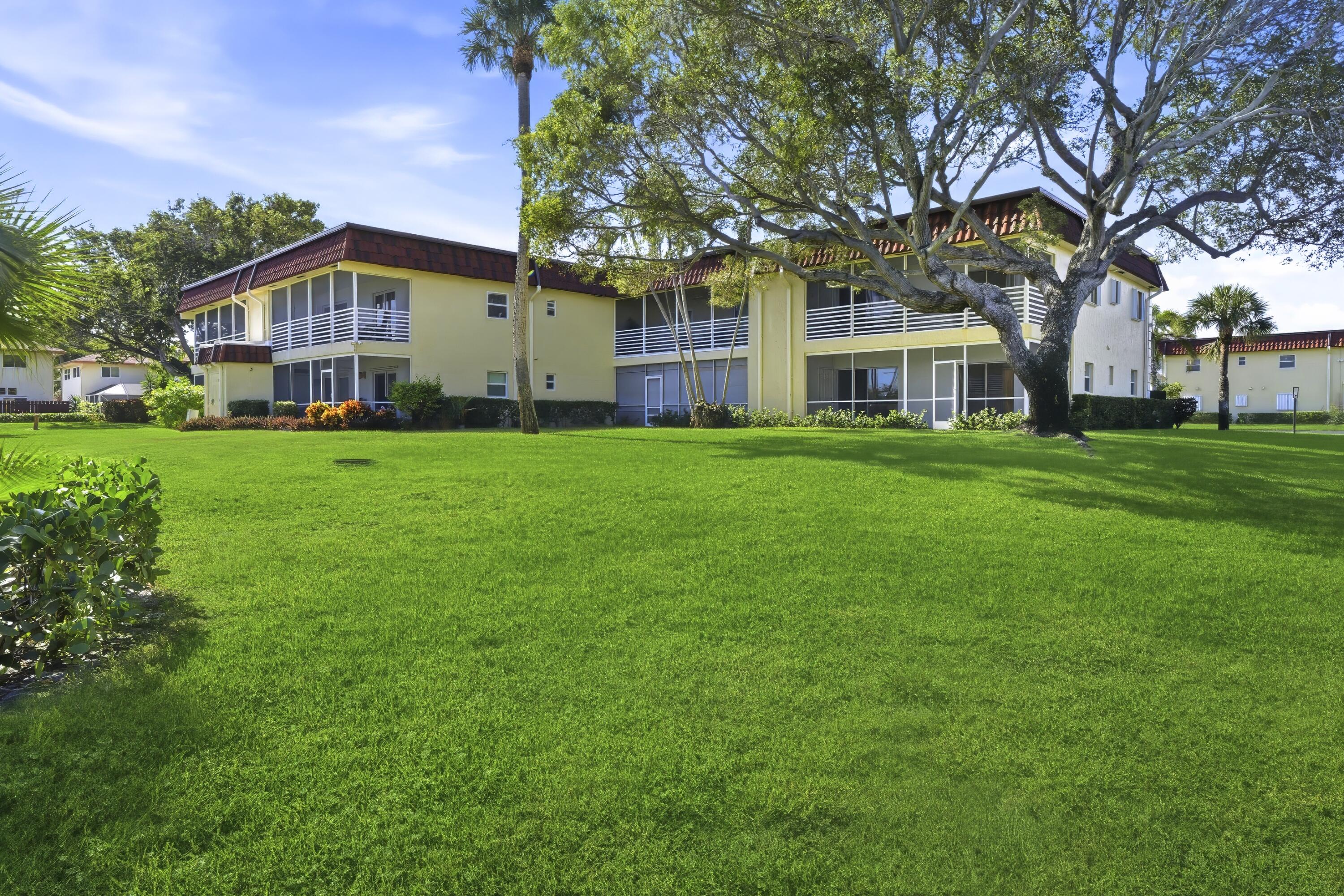 717 Highway 1, Unit 201 Jupiter, FL 33477 - Photo 18 of 31 a front view of a house with a garden and trees