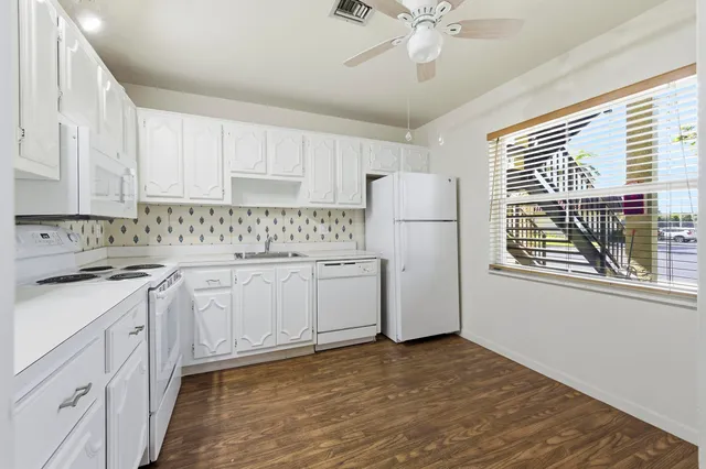 a kitchen with stainless steel appliances a refrigerator sink and cabinets