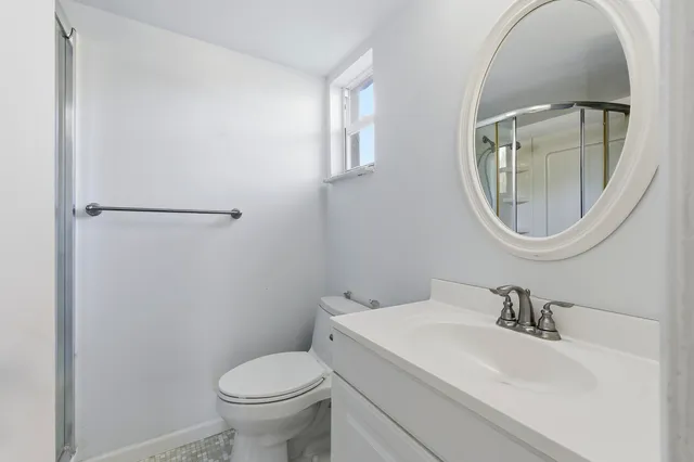 a white toilet sitting next to a bathroom sink