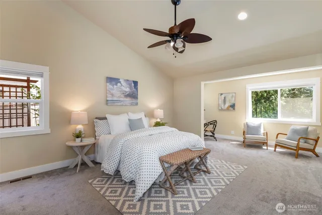 a bedroom with a bed a chandelier and a window