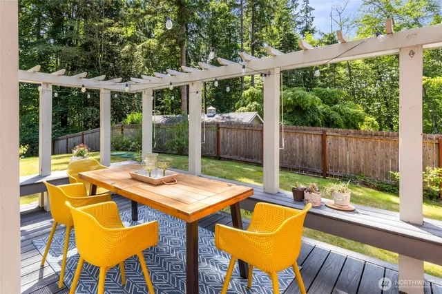 a view of a patio with a table chairs and a tub