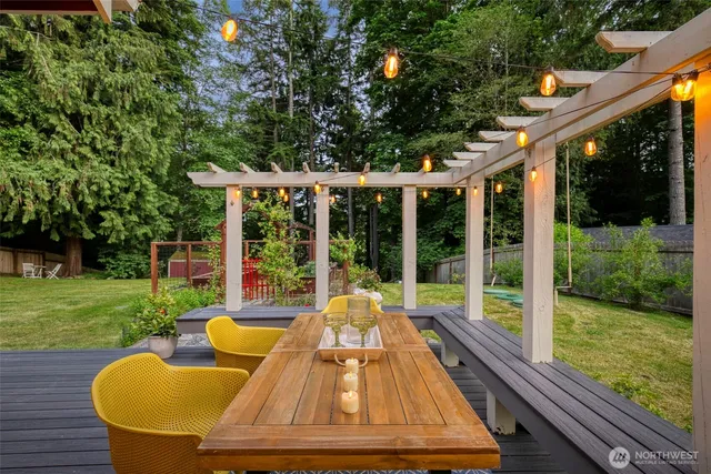 a view of swimming pool with a couple of chairs and a yard