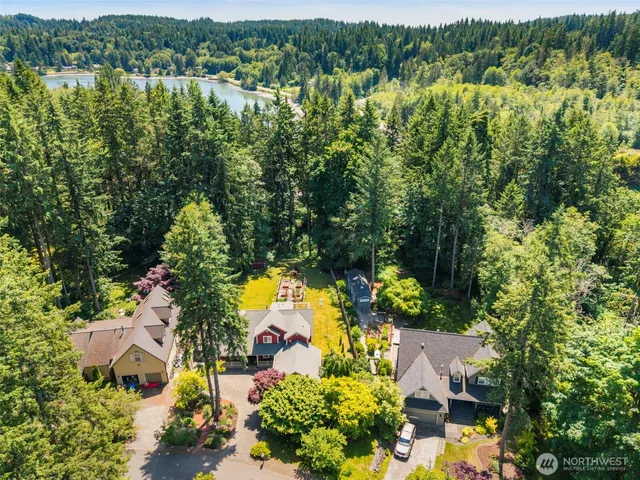 an aerial view of residential houses with outdoor space and trees
