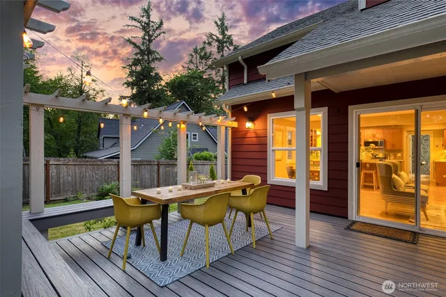 a view of a house with backyard sitting area and wooden floor