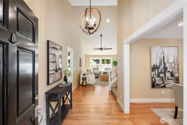 a view of a livingroom with furniture hardwood floor a chandelier