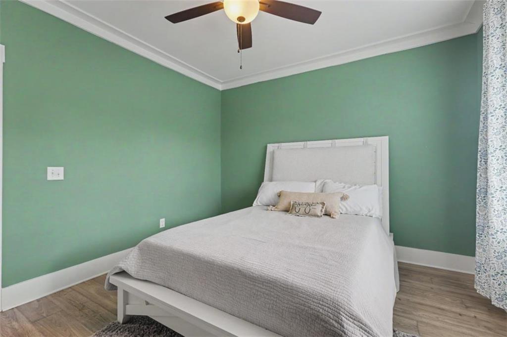 943 Clubside Drive Monroe, GA 30655 - Photo 35 of 93 a bedroom with a bed and a chandelier fan