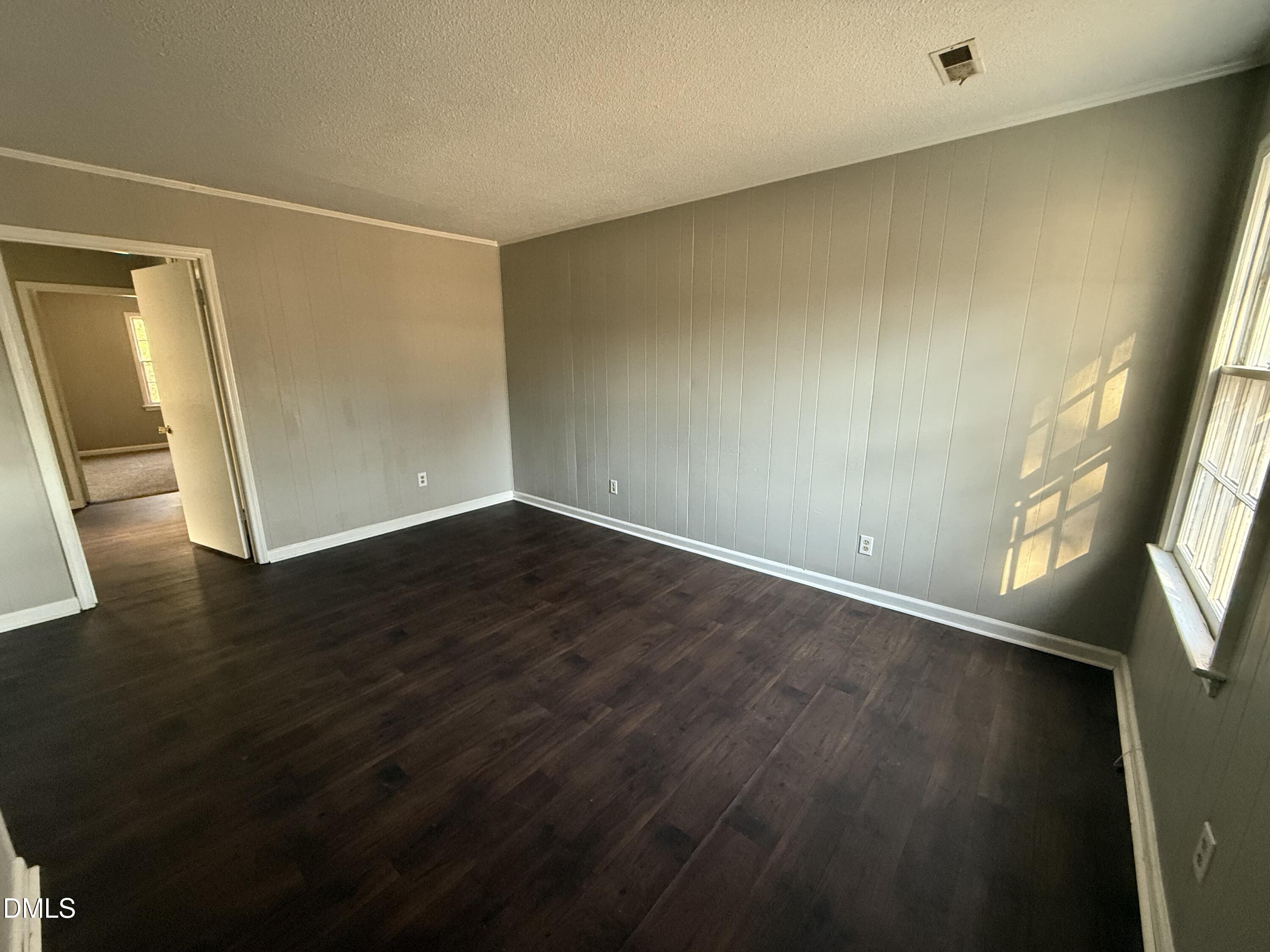 808 Crawford Street South Wilson, NC 27893 - Photo 11 of 11 a view of an empty room with wooden floor and a window