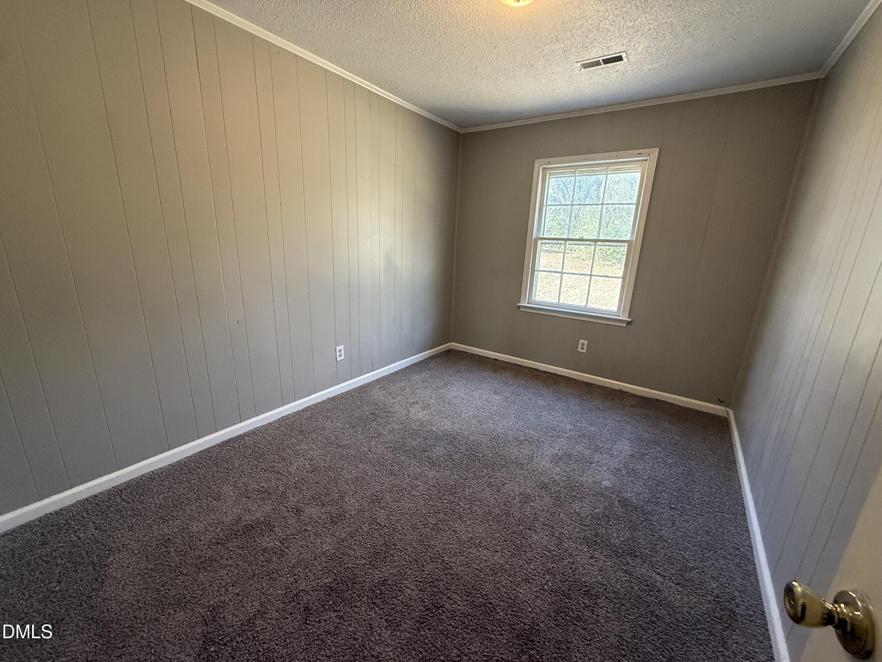 808 Crawford Street South Wilson, NC 27893 - Photo 4 of 11 an empty room with a window