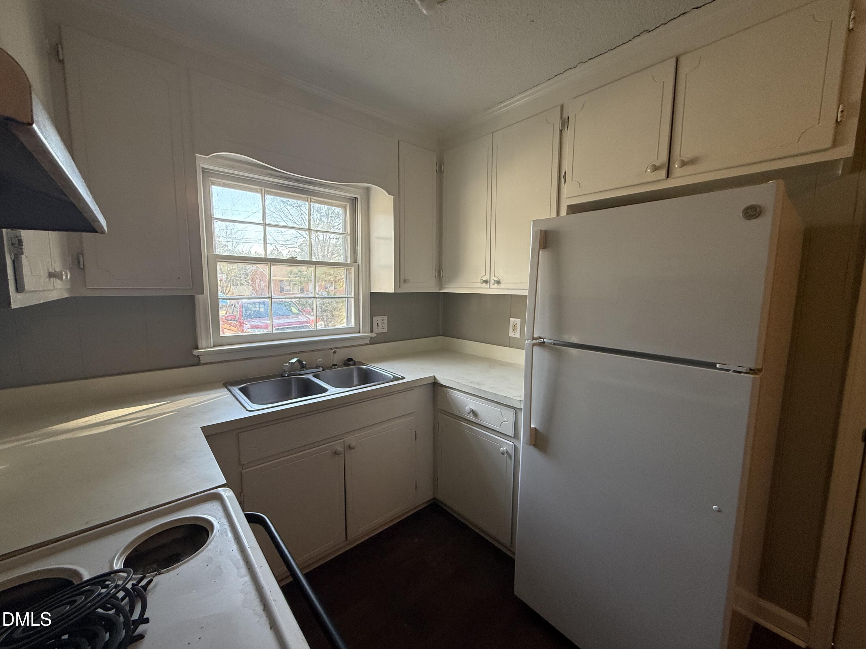 808 Crawford Street South Wilson, NC 27893 - Photo 5 of 11 a kitchen with a refrigerator sink and cabinets
