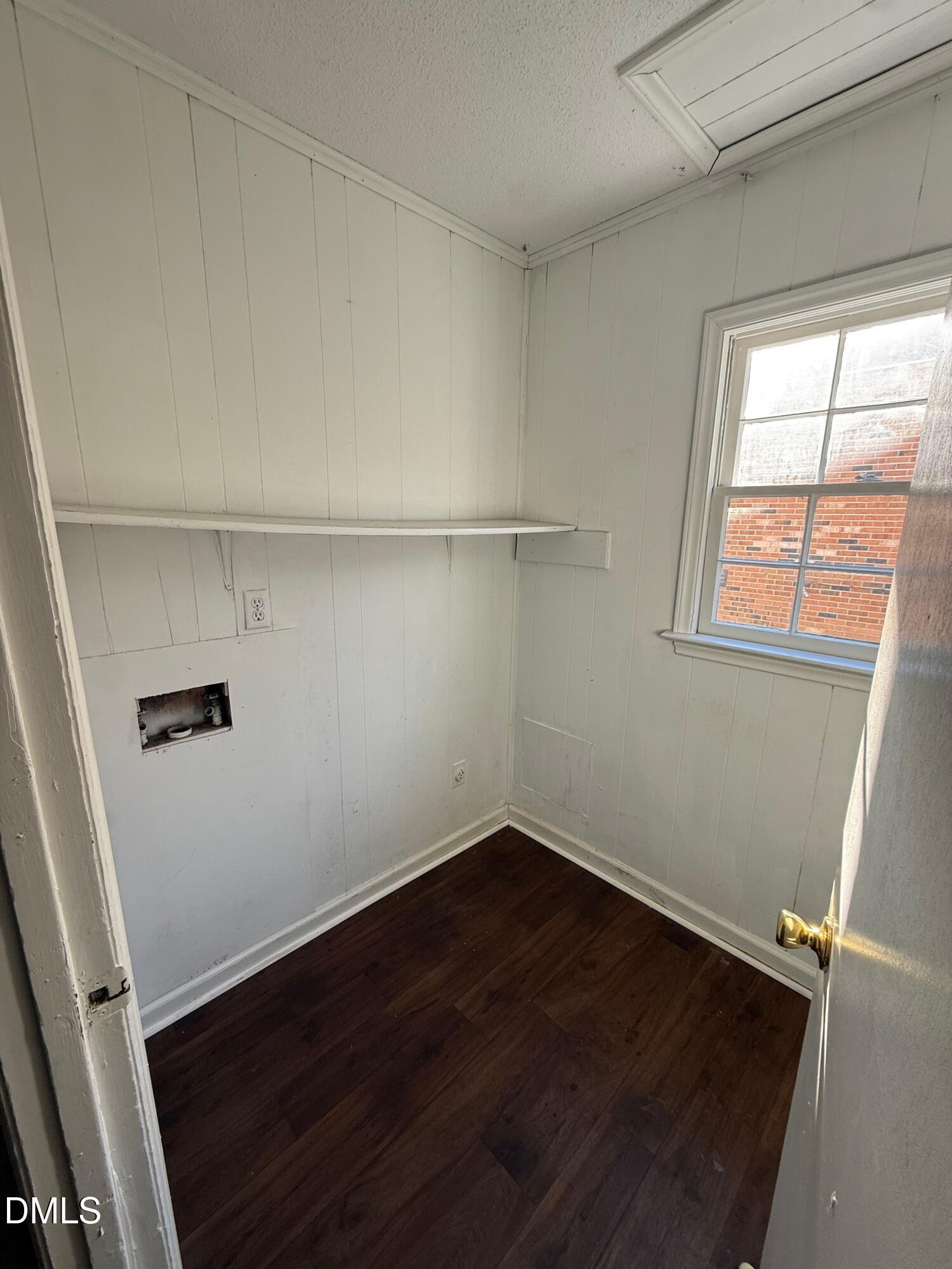 808 Crawford Street South Wilson, NC 27893 - Photo 9 of 11 an empty room with wooden floor and windows