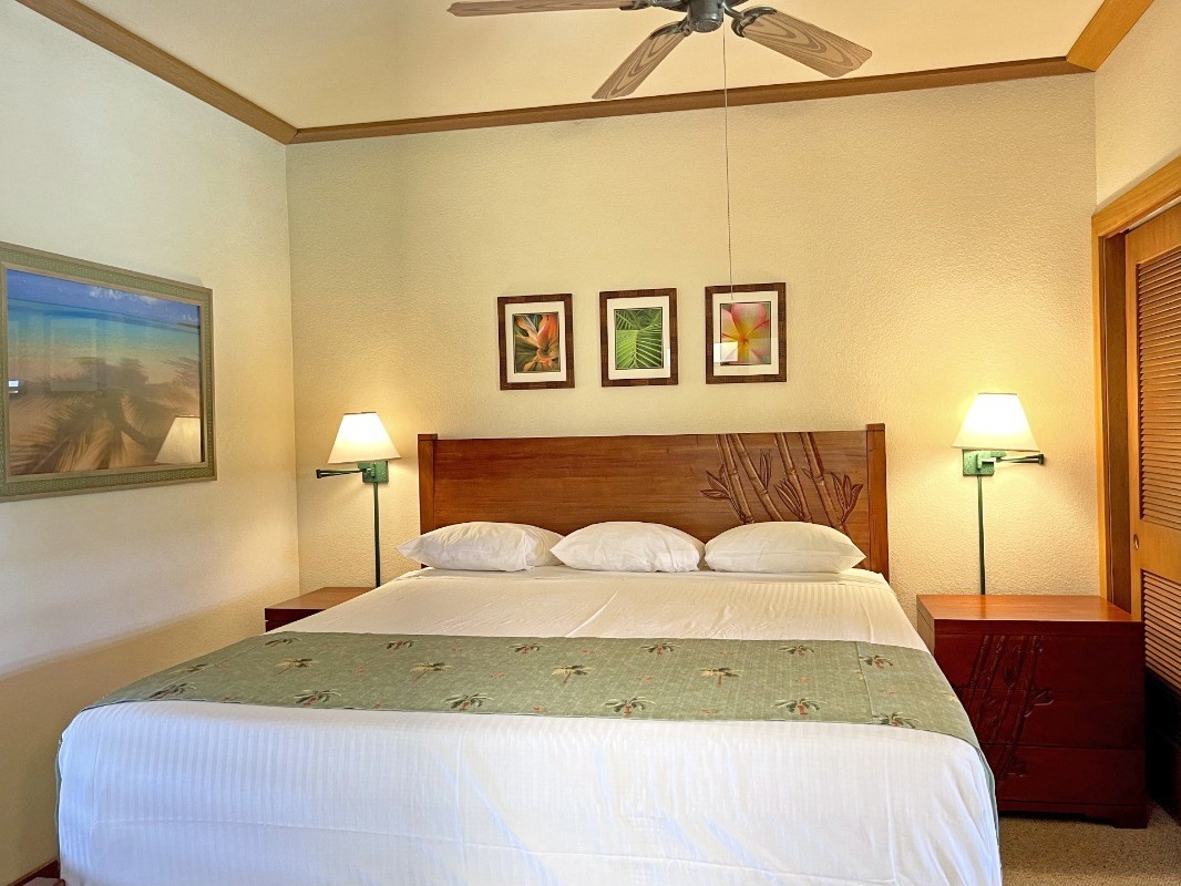 2253 Poipu Road, Unit 317 Koloa, HI 96756 - Photo 12 of 16 a bedroom with a bed and a painting on the wall