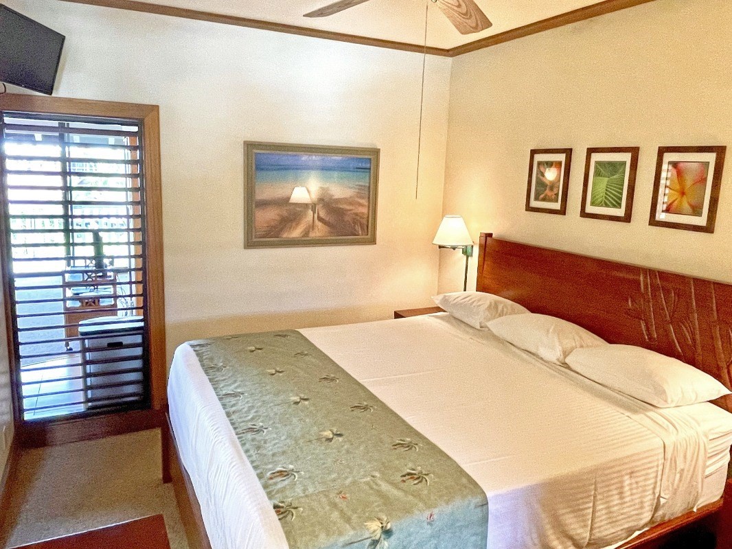 2253 Poipu Road, Unit 317 Koloa, HI 96756 - Photo 13 of 16 a bedroom with a bed and a cabinets
