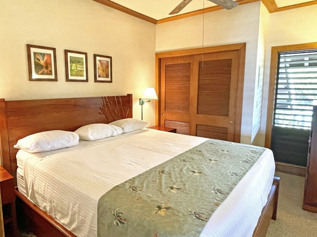 2253 Poipu Road, Unit 317 Koloa, HI 96756 - Photo 14 of 16 a bed sitting in a bedroom next to a window