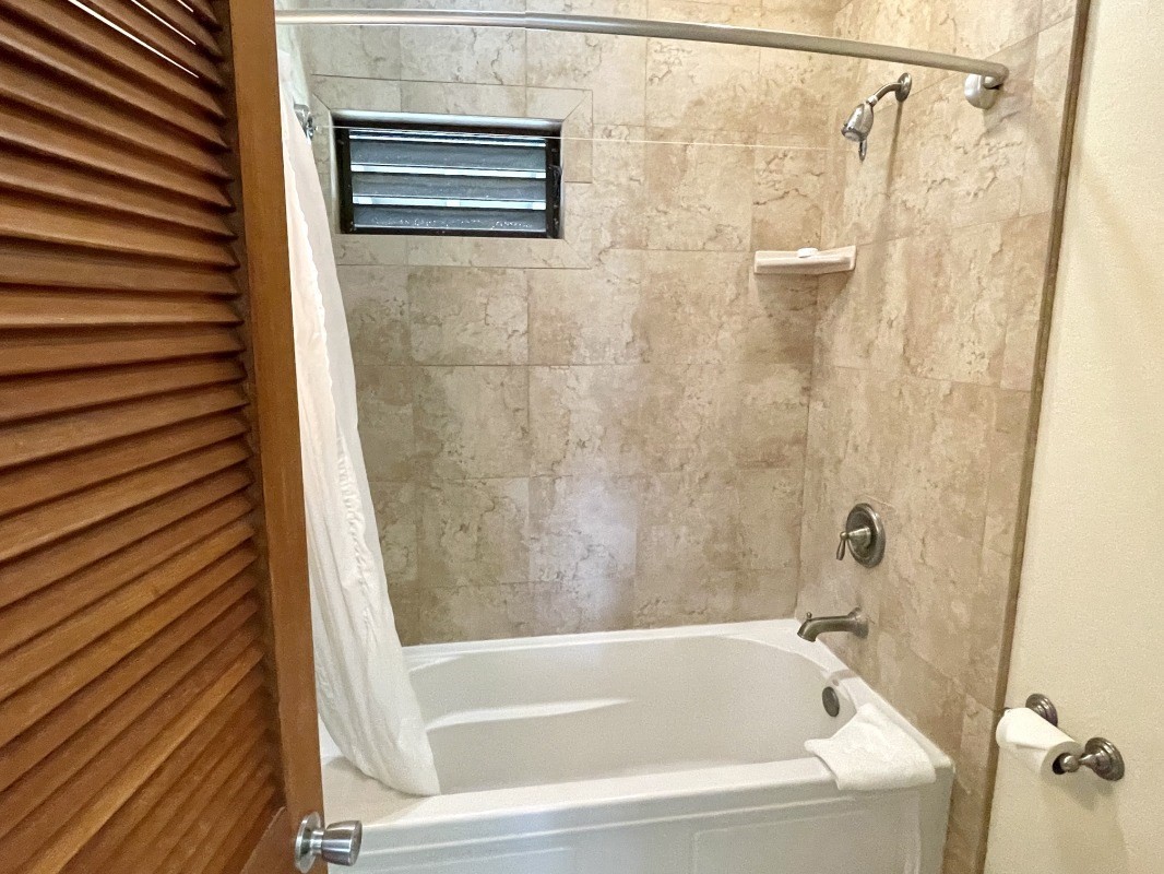 2253 Poipu Road, Unit 317 Koloa, HI 96756 - Photo 16 of 16 a bathroom with a shower and a bathtub