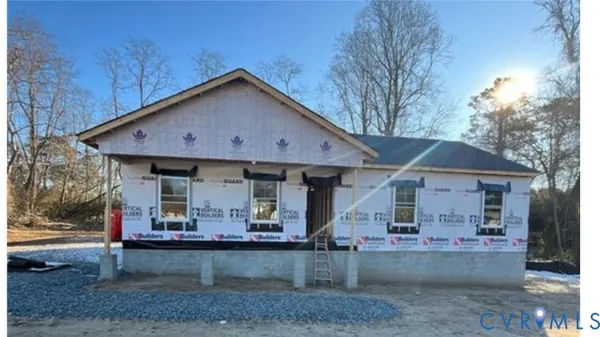 a view of a house with a yard and sitting area