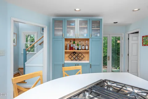 a large kitchen with a table and chairs