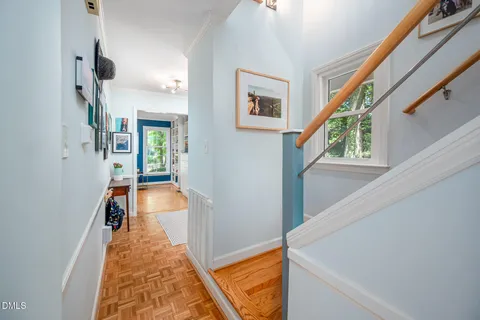 a view of a hallway with paintings on the wall