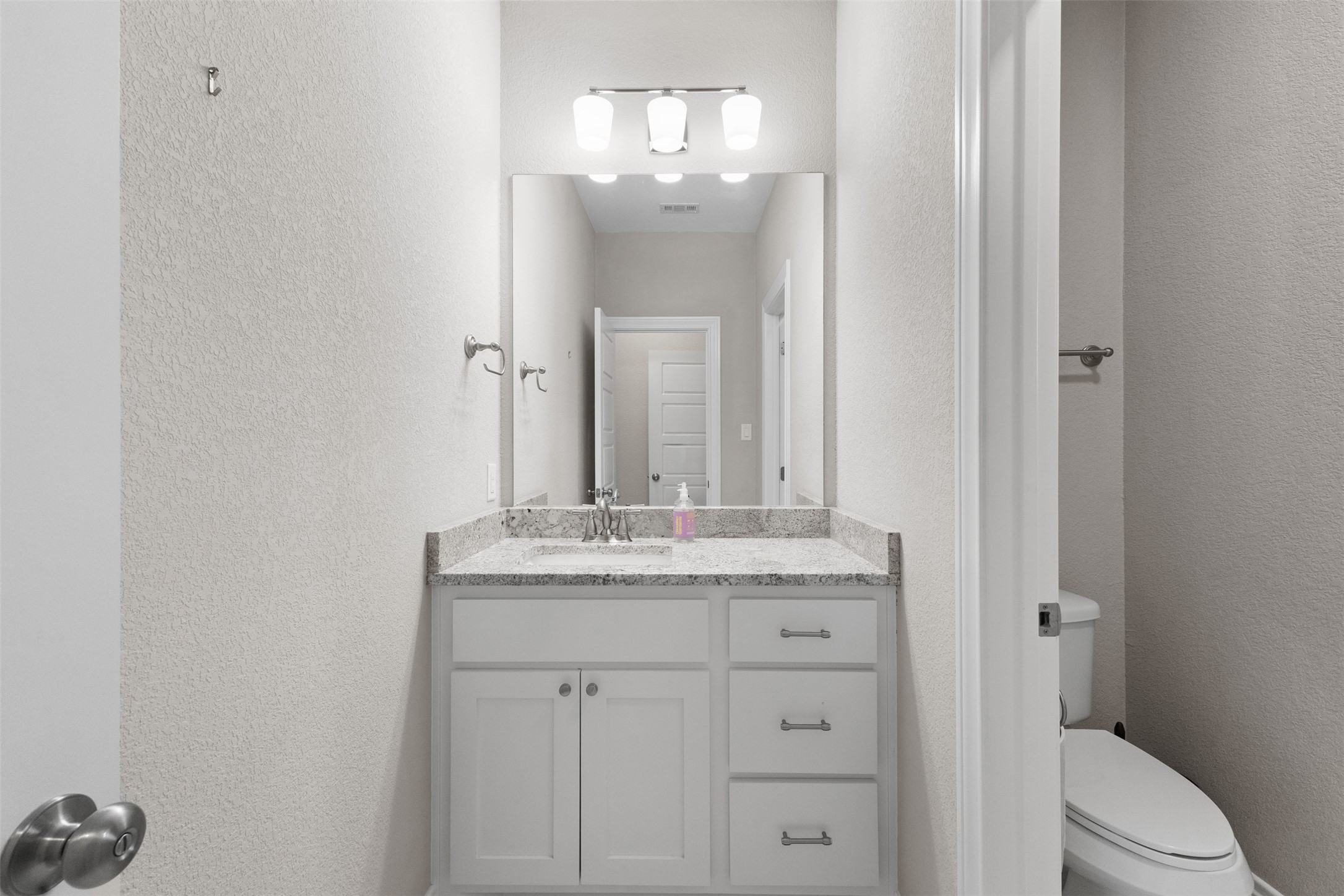 3010 Nobel Court Bryan, TX 77808 - Photo 16 of 23 a bathroom with a granite countertop sink a toilet and a mirror