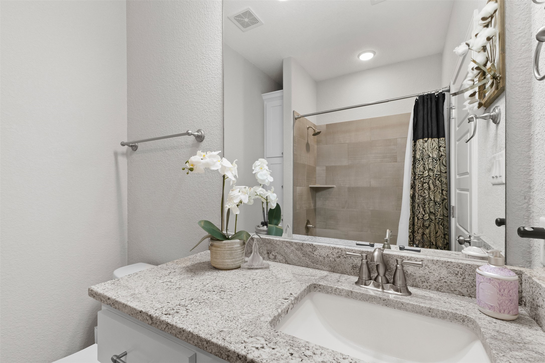 3010 Nobel Court Bryan, TX 77808 - Photo 19 of 23 a bathroom with a granite countertop sink and a mirror