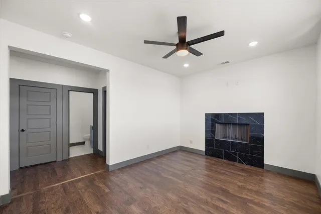 an empty room with closet and a ceiling fan