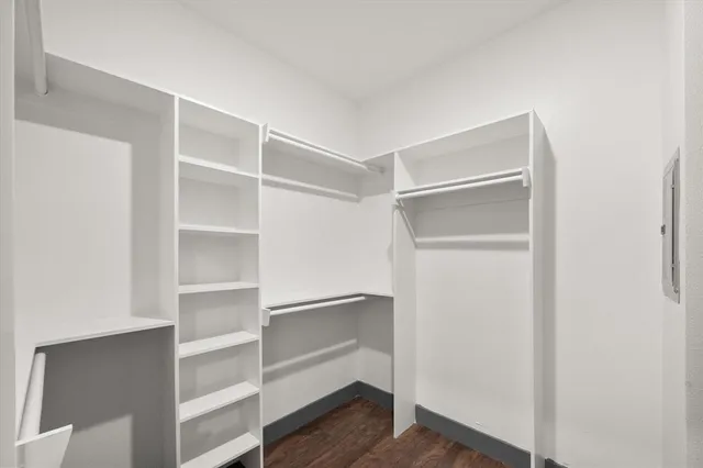 a view of walk in closet with empty racks