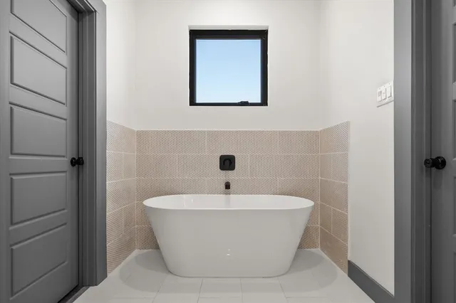 a white bath tub sitting in a bathroom