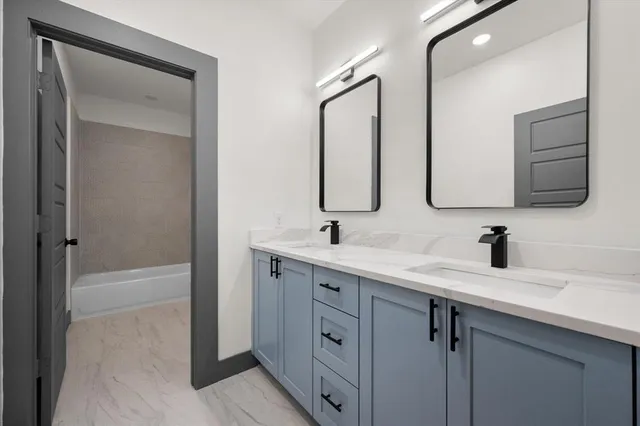 a bathroom with a double vanity sink mirror and
