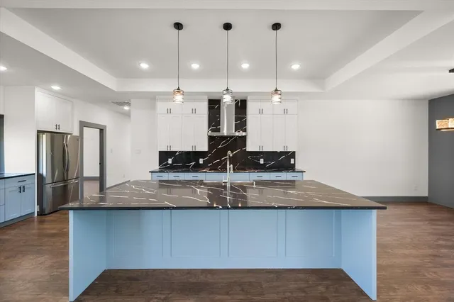 a view of a kitchen with a sink stainless steel appliances and cabinets