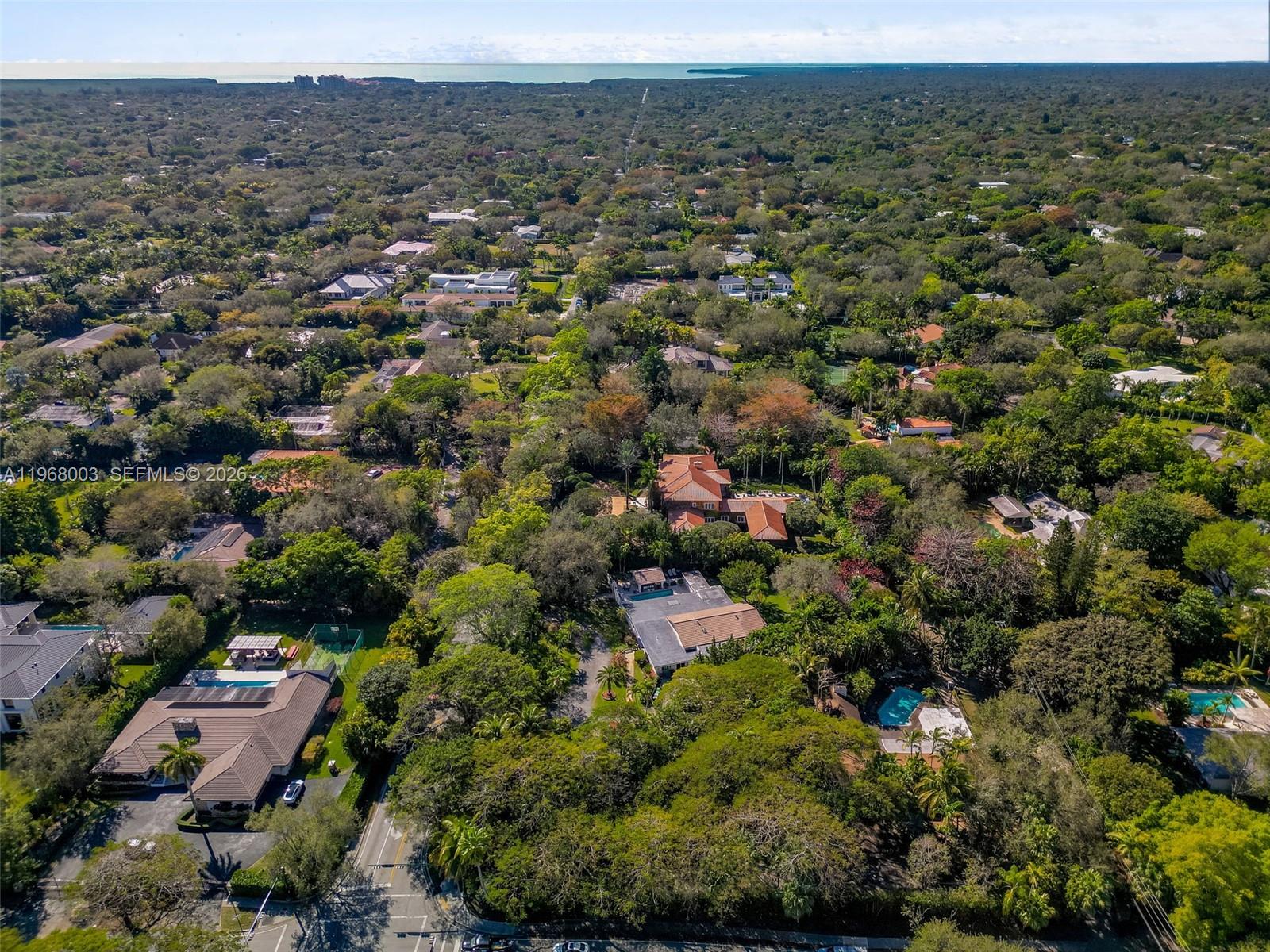 11220 Southwest 67th Avenue Pinecrest, FL 33156 - Photo 11 of 42 an aerial view of a town with trees