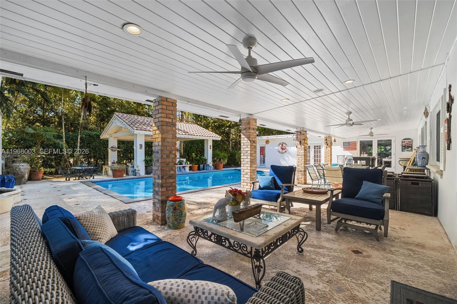 11220 Southwest 67th Avenue Pinecrest, FL 33156 - Photo 18 of 42 a outdoor space with patio the couches and a dining table with the garden view