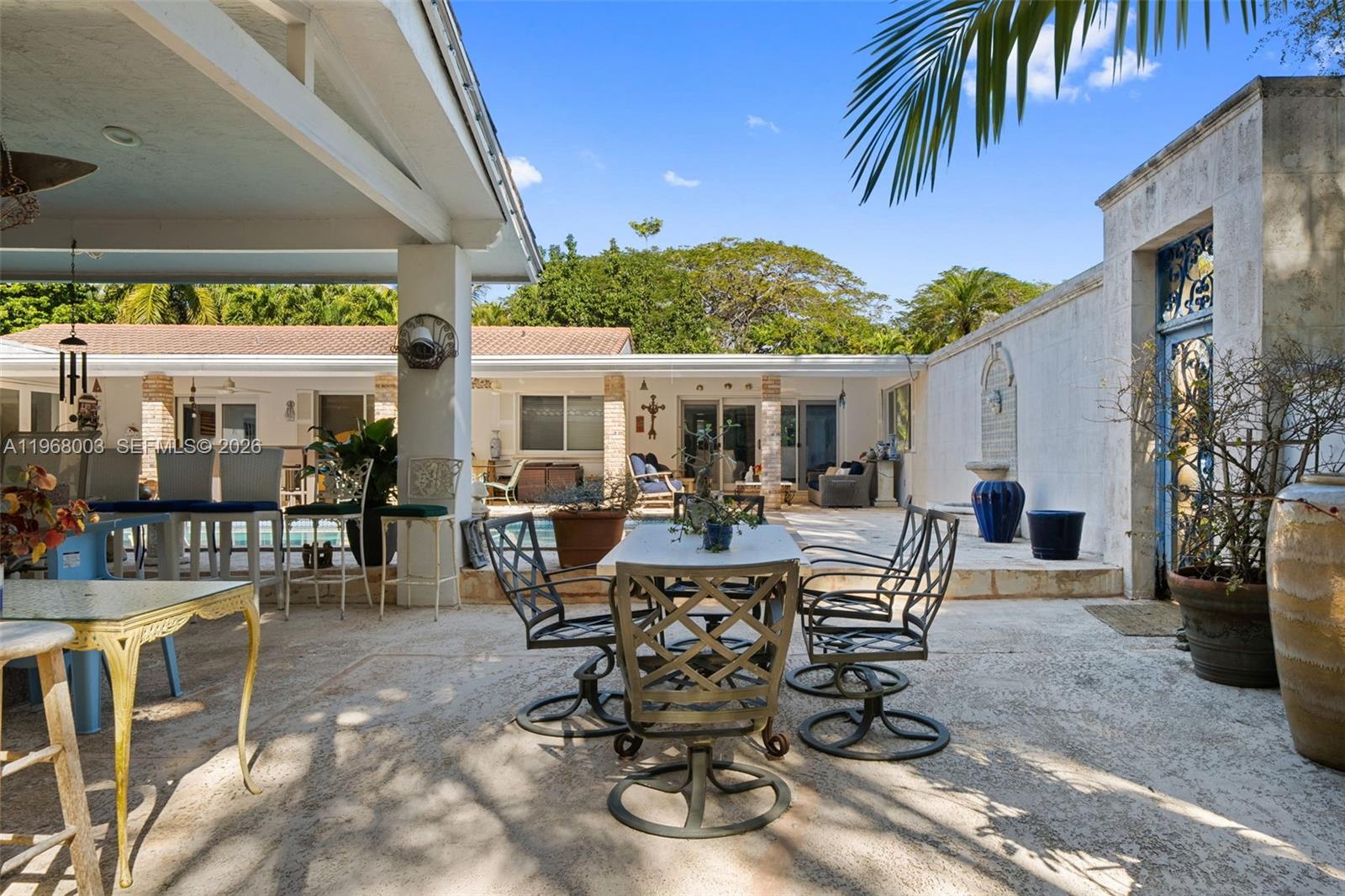 11220 Southwest 67th Avenue Pinecrest, FL 33156 - Photo 20 of 42 a view of a patio with table and chairs and potted plants